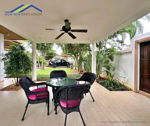 Covered outdoor patio with table and chairs