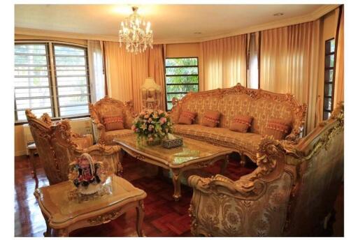 Elegantly furnished living room with chandelier and large windows