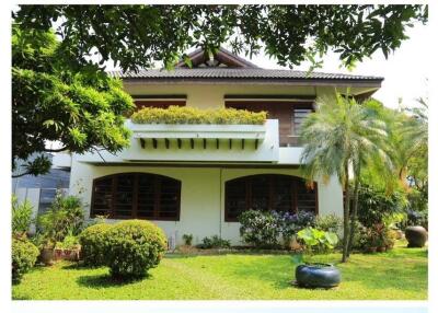 Exterior view of a two-story house with a garden