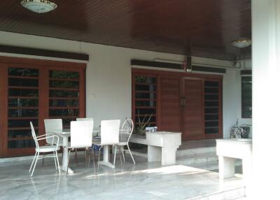 Outdoor patio with seating area and carport