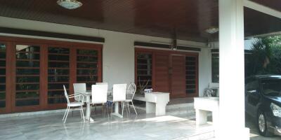 Outdoor patio with seating area and carport