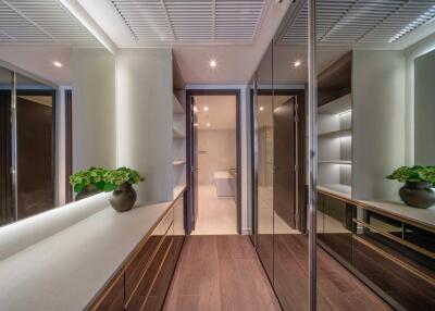 Modern hallway with mirrors, plants, and shelves