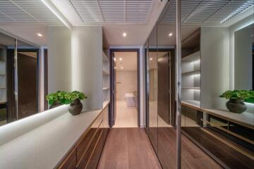 Modern hallway with mirrors, plants, and shelves