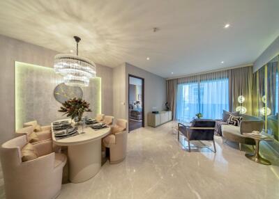 Modern living and dining area with elegant furnishings and chandelier