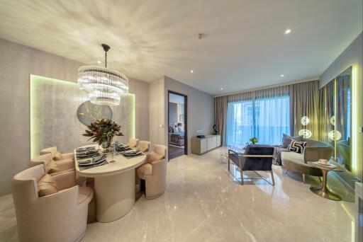 Modern living and dining area with elegant furnishings and chandelier