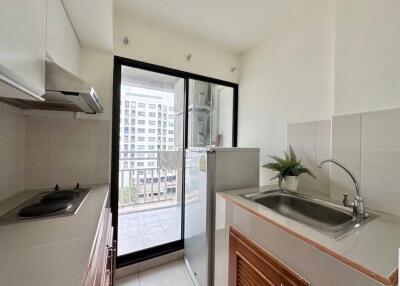 Small modern kitchen with balcony view