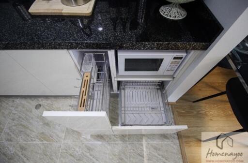 Modern kitchen with dishwasher, microwave, and granite countertop