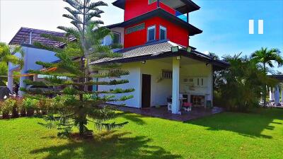 Modern house with red accent and outdoor amenities