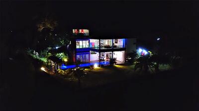 Night view of a modern two-story house with illuminated exterior