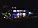 Night view of a modern two-story house with illuminated exterior