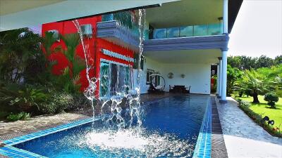 Modern house with a view of the swimming pool and greenery