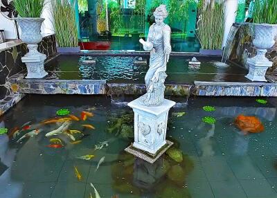 Indoor water feature with statue and fish pond