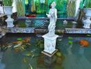 Indoor water feature with statue and fish pond