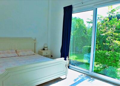 Spacious bedroom with large window and garden view