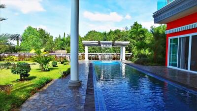 Outdoor pool area with garden