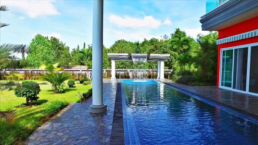 Outdoor pool area with garden