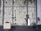 Home gym with stone accent wall