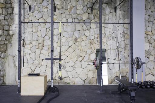 Home gym with stone accent wall