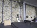 Home gym with stone wall and fitness equipment