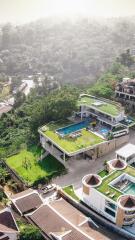 Aerial view of a modern villa with pool and rooftop garden