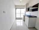 Modern kitchen with white cabinets and a balcony view