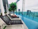 Rooftop swimming pool with city views and lounge chairs