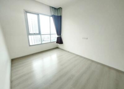 empty bedroom with large window and curtains