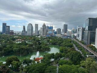 View of city skyline and park with lake