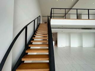 Modern interior with wooden staircase and loft space