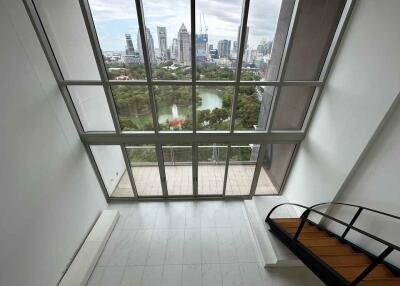 Spacious living room with large windows and city view