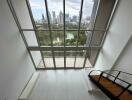 Spacious living room with large windows and city view