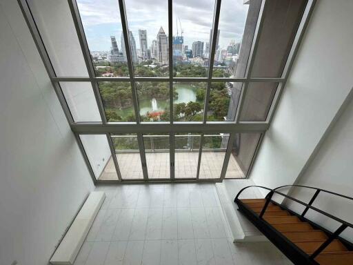 Spacious living room with large windows and city view