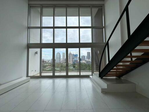 Modern living room with large windows and city view