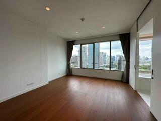 Spacious empty living room with large window and city view