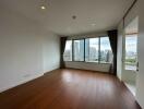 Spacious empty living room with large window and city view