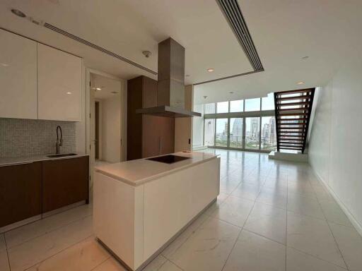 Modern kitchen with island and view of open living space