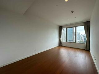 Spacious bedroom with large window and city view