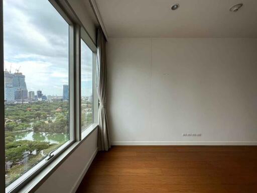 Empty living room with large windows and city view