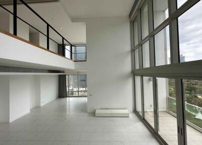 Spacious living room with high ceilings and large windows