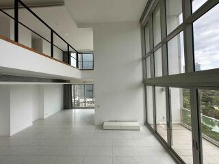 Spacious living room with high ceilings and large windows