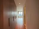 Spacious hallway leading to a large window with city views