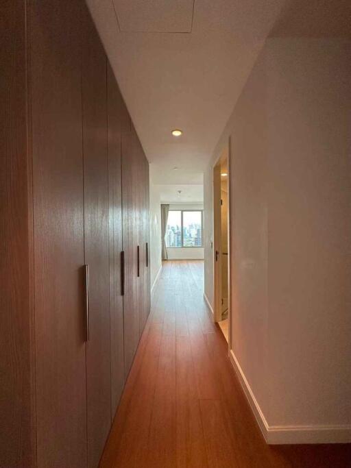 Spacious hallway leading to a large window with city views