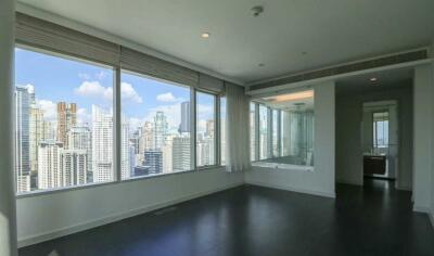 Spacious living area with large windows and city view