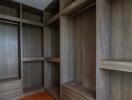 Spacious walk-in closet with wooden shelves and drawers