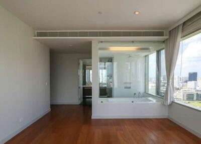 Modern bathroom with large windows and wooden floor