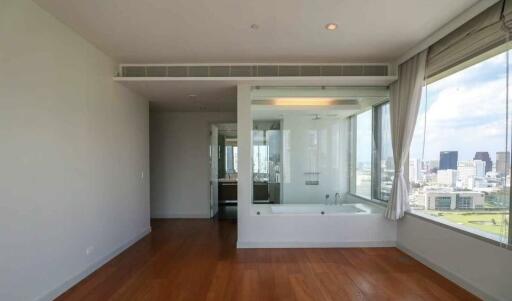 Modern bathroom with large windows and wooden floor