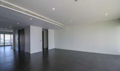 Spacious living room with modern fixtures and dark floor tiles