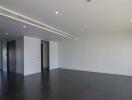 Spacious living room with modern fixtures and dark floor tiles