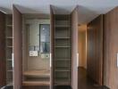 closet with open doors showing shelves and electrical panel