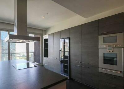 Modern kitchen with dark cabinetry and built-in appliances